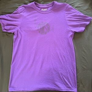 Classic Phish logo camouflaged on purple tee.